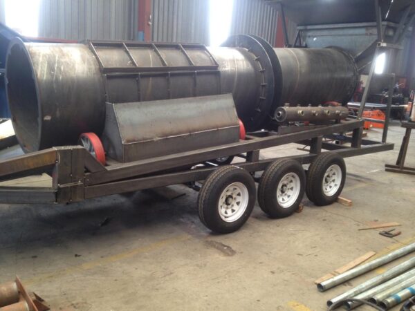 RHT-4, 15-20 TPH Reverse Helix Trommel Wash Plant, build onto a double axle trailer and fitted with jack stands.