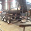 RHT-4, 15-20 TPH Reverse Helix Trommel Wash Plant, build onto a double axle trailer and fitted with jack stands.